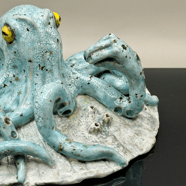 Italian hand gesture octopus on scallop shell